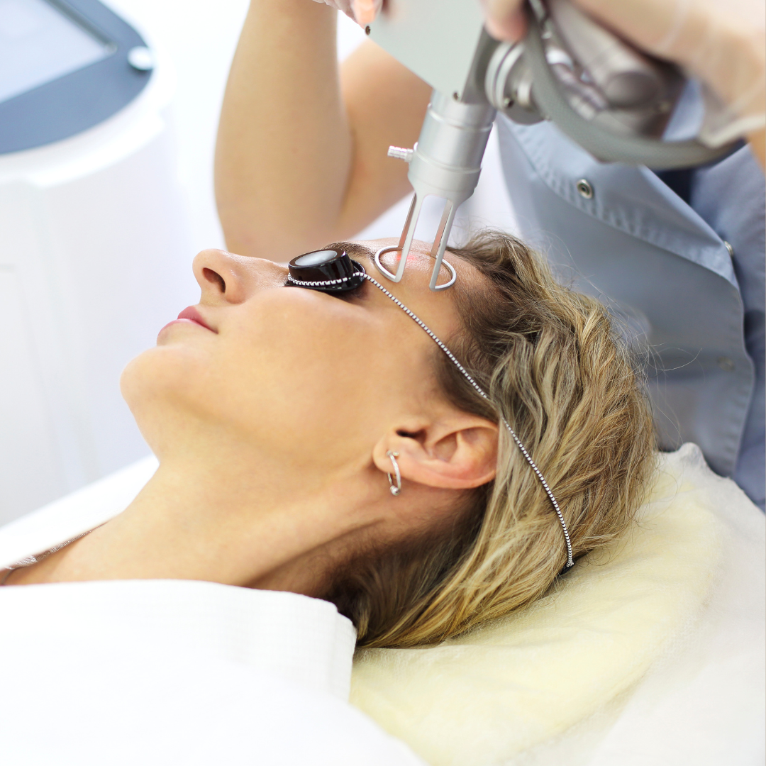 Laser technician performing skin resurfacing on a female client